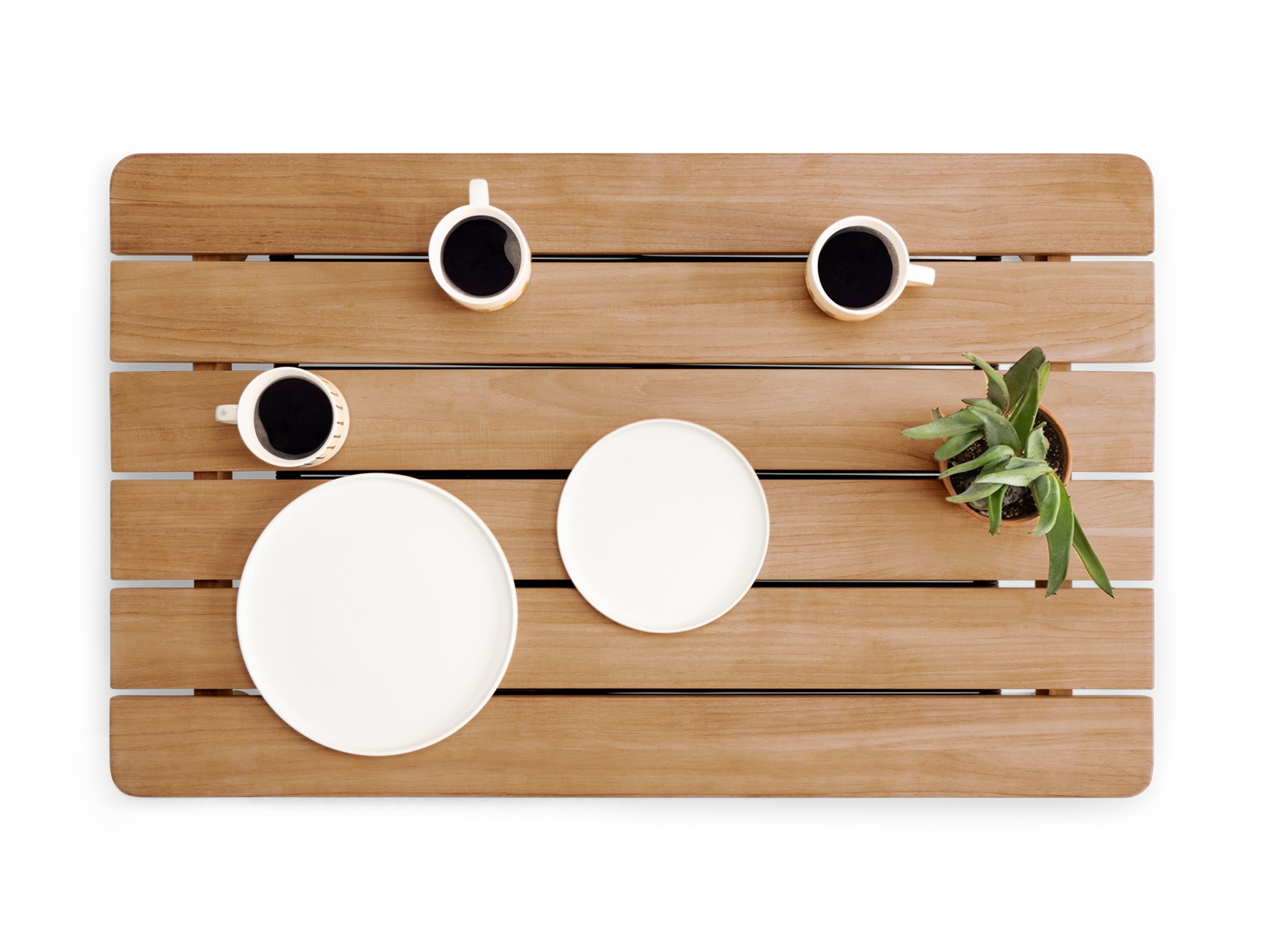Overhead view of wooden outdoor coffee table with dishes on it
